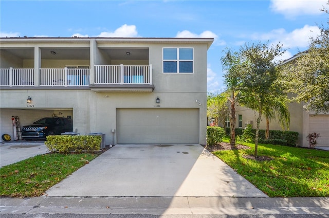 view of front of house featuring a balcony, a front lawn, and a garage