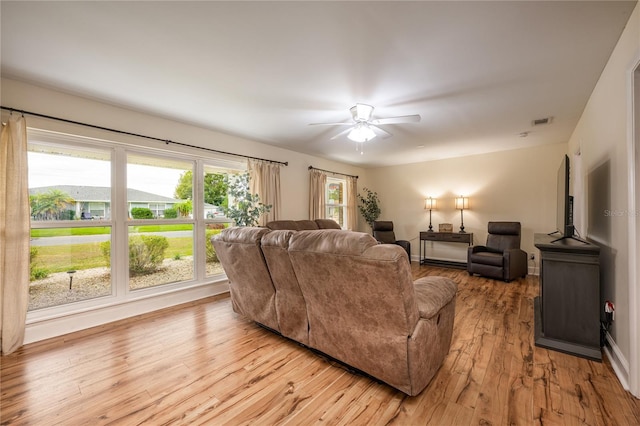 living room with light hardwood / wood-style flooring and a healthy amount of sunlight