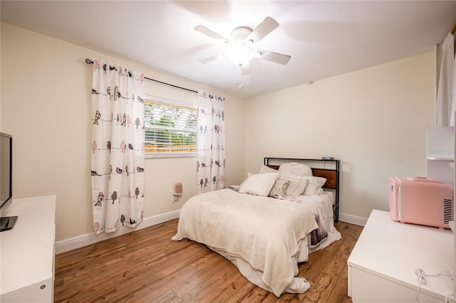 bedroom with hardwood / wood-style floors and ceiling fan