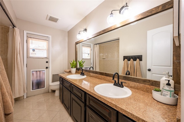 bathroom featuring tile patterned floors, vanity, and toilet