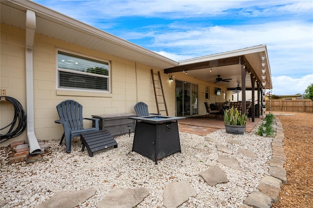 view of patio / terrace with ceiling fan and a fire pit