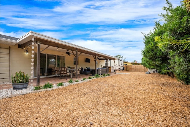 view of yard featuring a patio and ceiling fan