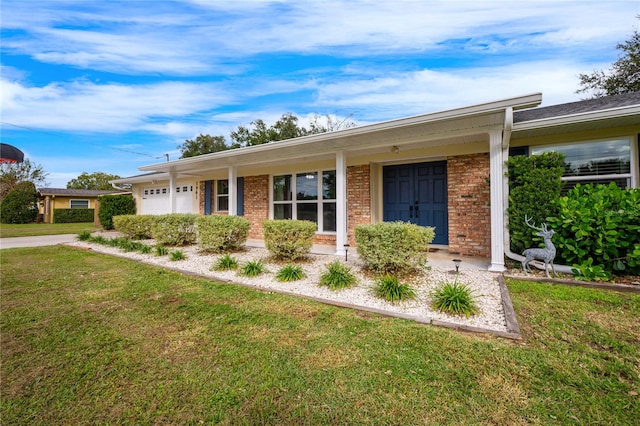 single story home with a garage and a front lawn