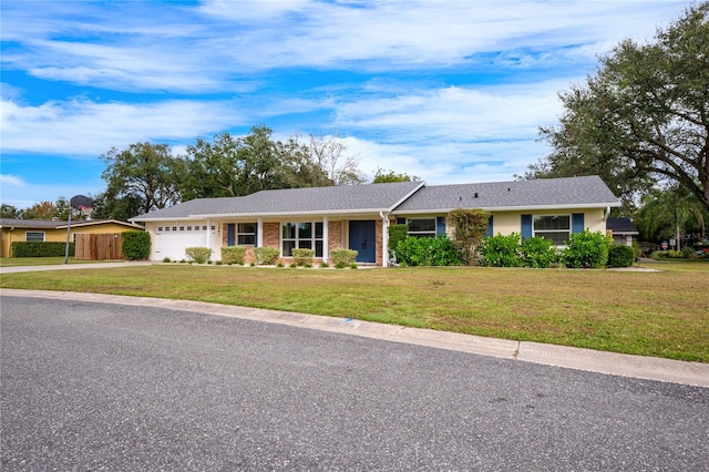 single story home with a garage and a front lawn