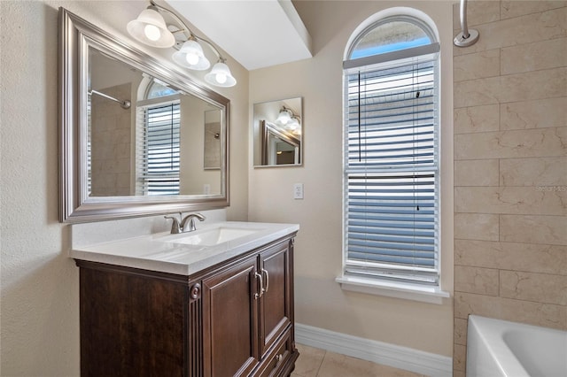 bathroom with tiled shower / bath combo, vanity, and tile patterned floors