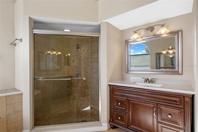 bathroom with walk in shower and vanity