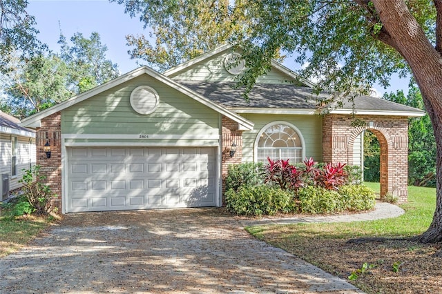 ranch-style house featuring brick siding, driveway, a garage, and central AC unit