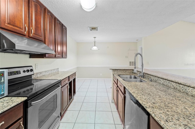 kitchen with light stone countertops, sink, stainless steel appliances, pendant lighting, and a textured ceiling