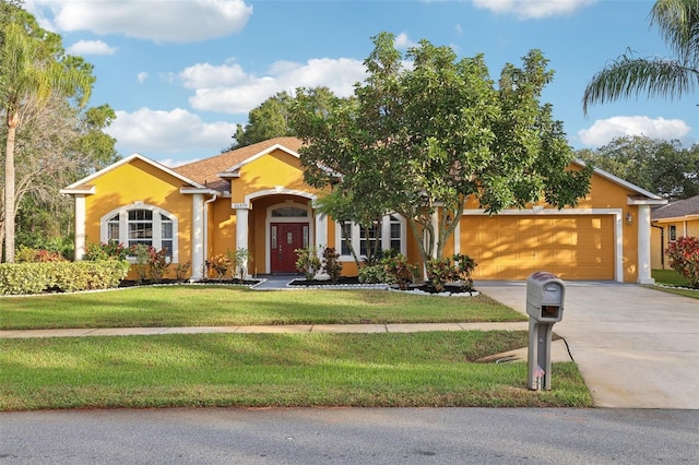 ranch-style home with a front yard and a garage