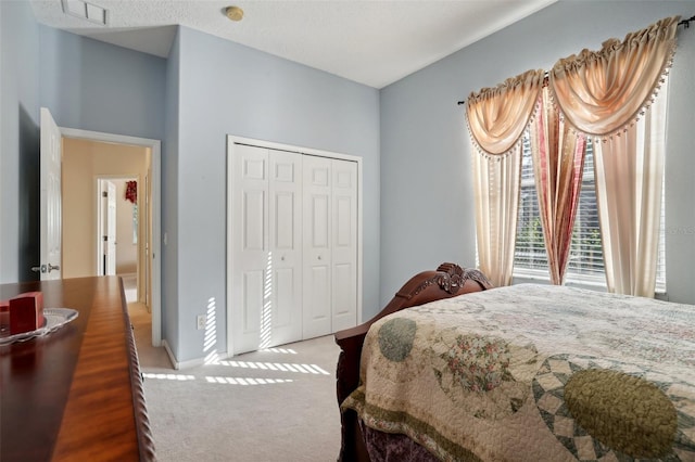 carpeted bedroom with a closet