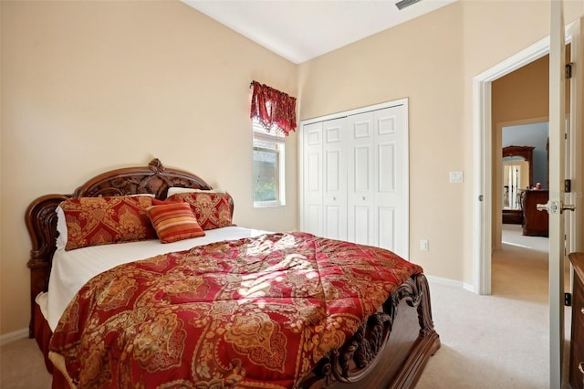 bedroom with a closet and light carpet