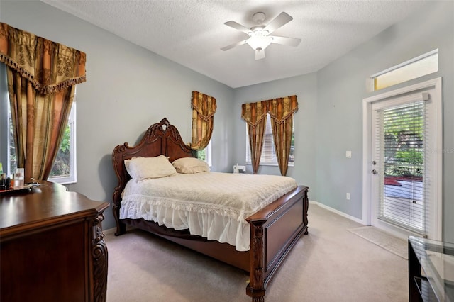 bedroom featuring a textured ceiling, light colored carpet, ceiling fan, and access to outside