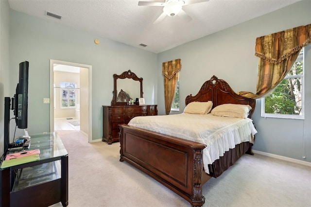 carpeted bedroom with a textured ceiling and ceiling fan