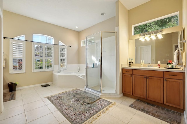 bathroom with plus walk in shower, tile patterned flooring, and vanity