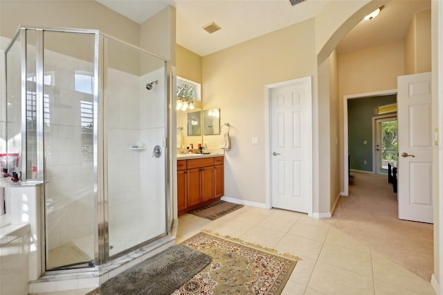 bathroom featuring vanity, tile patterned floors, and an enclosed shower