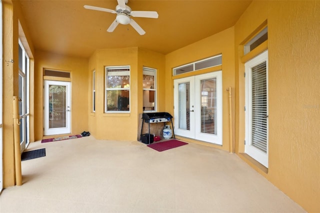 sunroom with ceiling fan and french doors