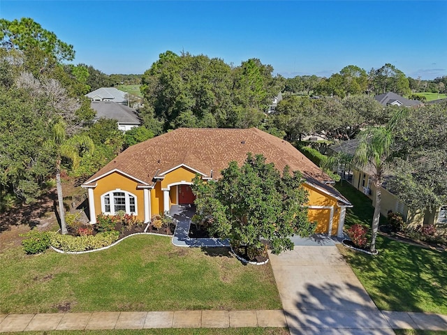 view of front of home with a garage and a front yard