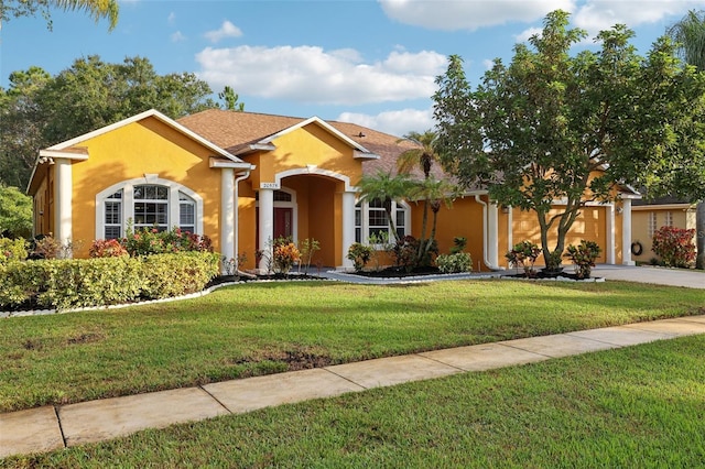 ranch-style home with a garage and a front lawn