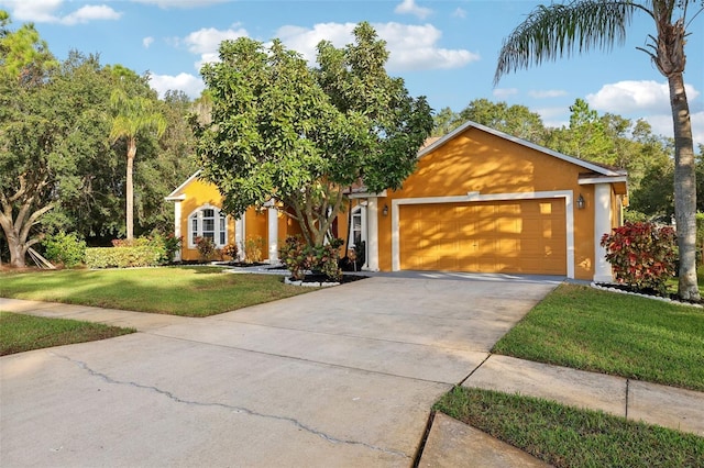 view of front of home with a garage and a front yard