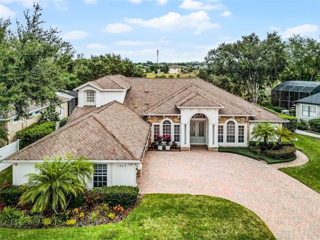 mediterranean / spanish-style home featuring a front yard