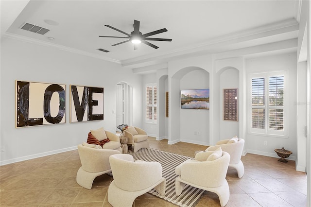 living area featuring ceiling fan, light tile patterned floors, and ornamental molding