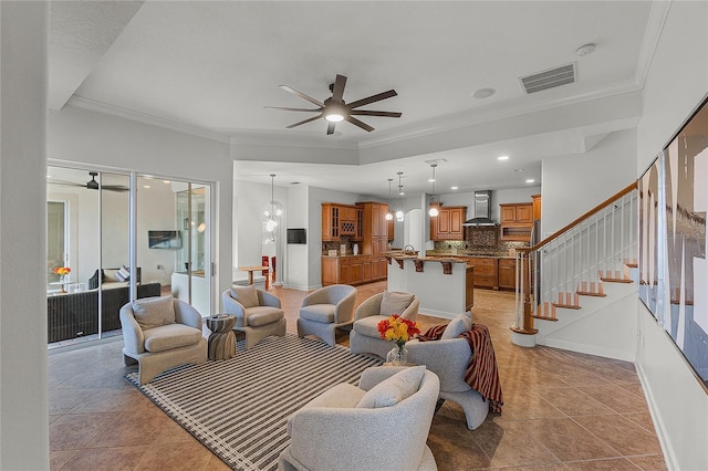 tiled living room with ceiling fan and ornamental molding