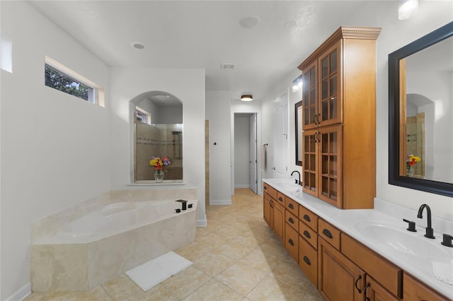 bathroom with tile patterned floors, plus walk in shower, and vanity