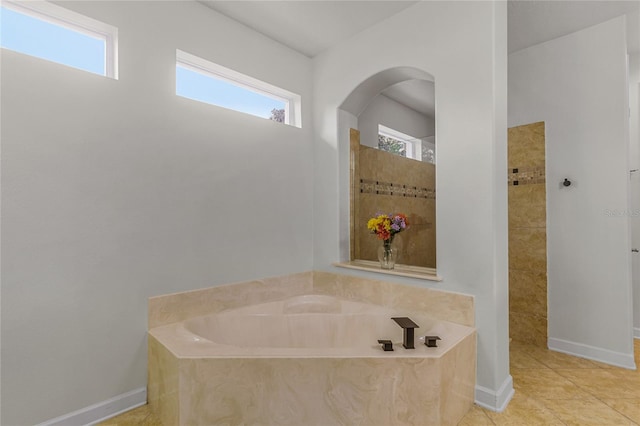 bathroom featuring separate shower and tub and tile patterned flooring