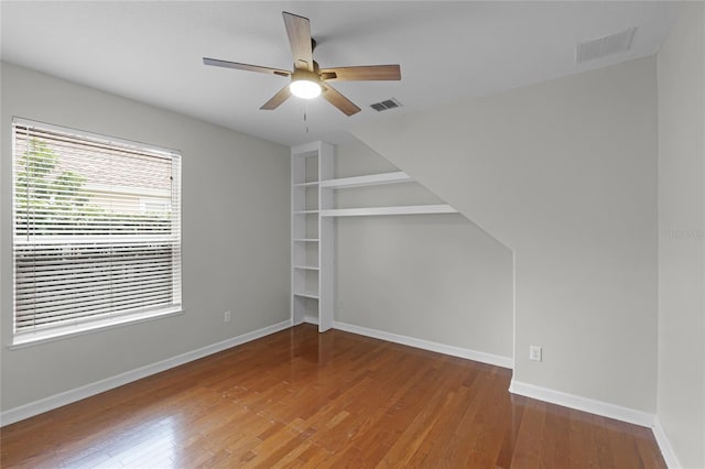 spare room with ceiling fan and wood-type flooring