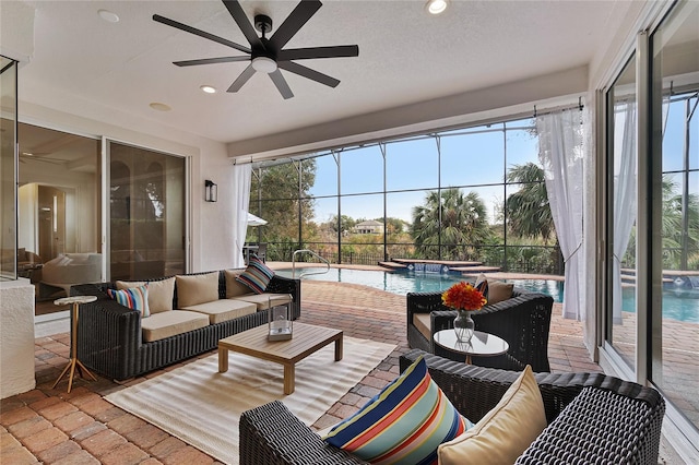 sunroom / solarium featuring ceiling fan and a pool