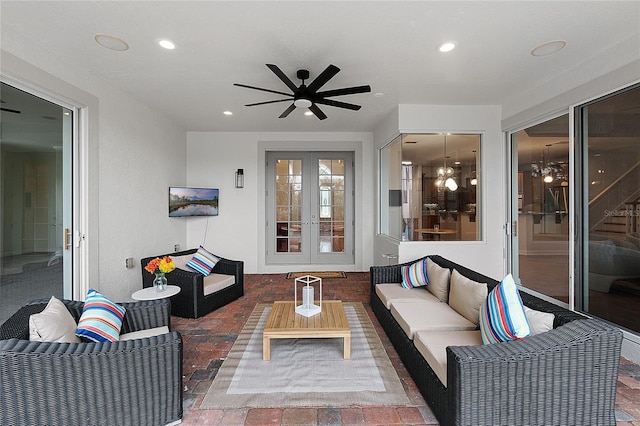 living room featuring french doors and ceiling fan