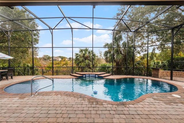 view of pool featuring pool water feature, glass enclosure, and a patio