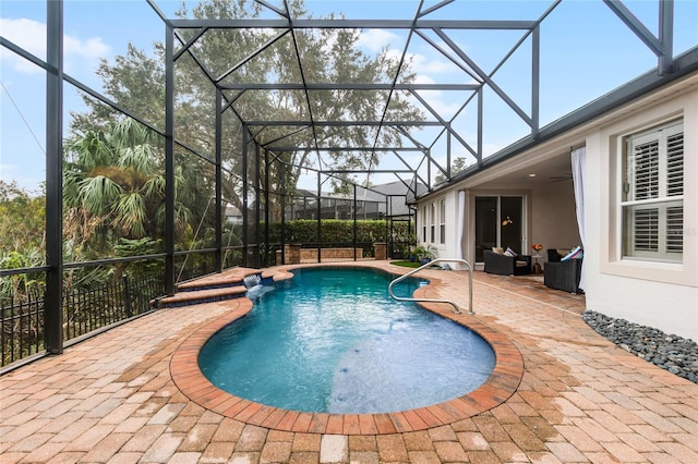 view of pool with glass enclosure, ceiling fan, and a patio