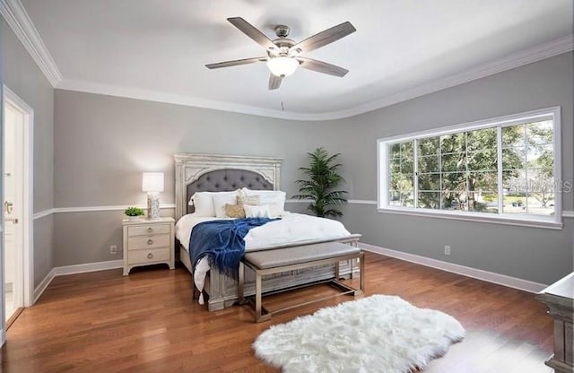 bedroom with dark hardwood / wood-style flooring, ceiling fan, and ornamental molding