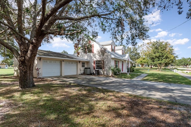 view of front of property with a garage, central air condition unit, and a front yard