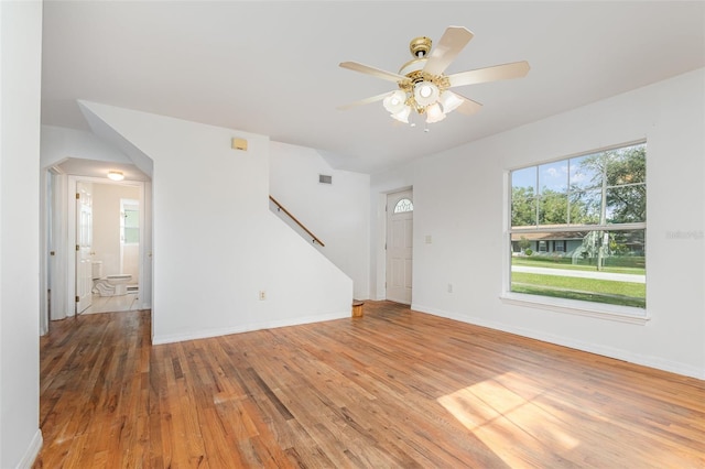 unfurnished living room with ceiling fan and wood-type flooring