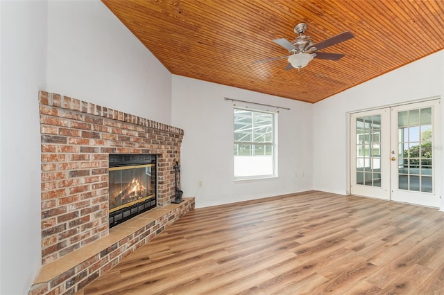 unfurnished living room with french doors, light wood-type flooring, ceiling fan, wooden ceiling, and a fireplace