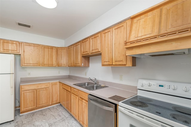 kitchen with light brown cabinetry, white appliances, and sink