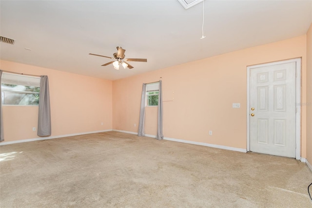 empty room featuring light colored carpet and ceiling fan