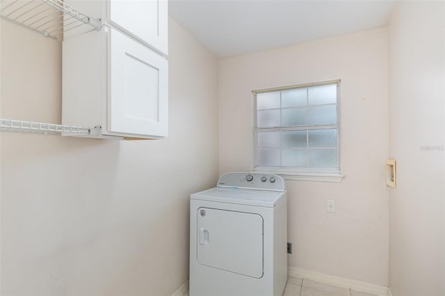 laundry room featuring cabinets, washer / dryer, and light tile patterned floors