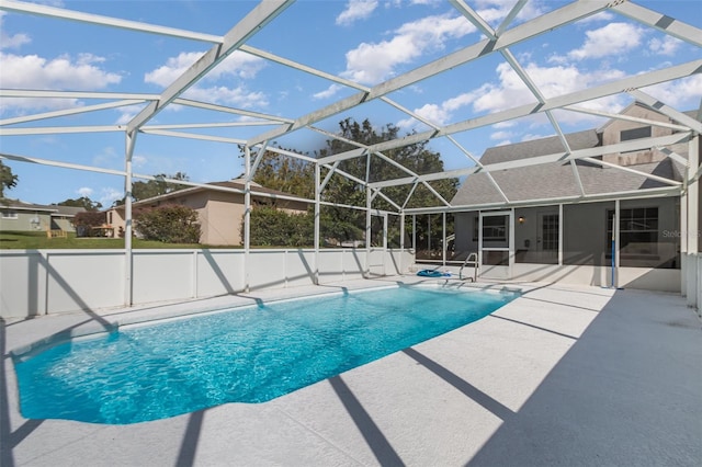 view of swimming pool with a patio and a lanai