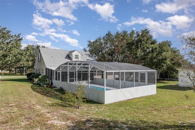 view of swimming pool featuring a lanai and a yard