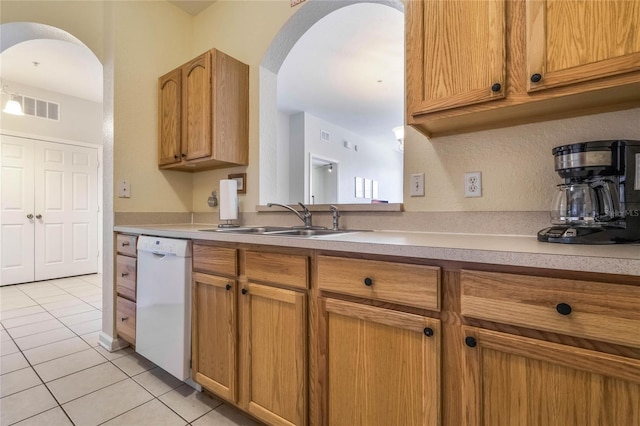 kitchen with light tile patterned floors, dishwasher, and sink