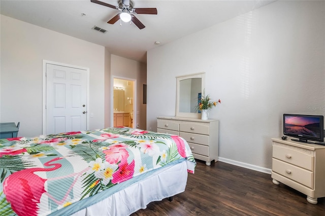 bedroom featuring dark hardwood / wood-style flooring, ceiling fan, and connected bathroom