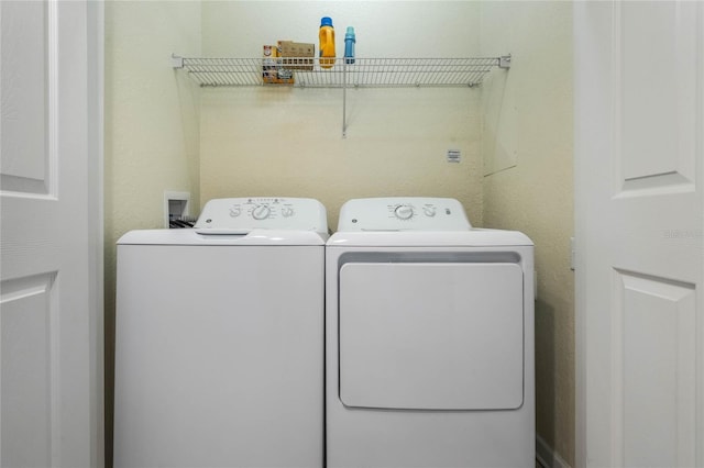 washroom with washing machine and clothes dryer