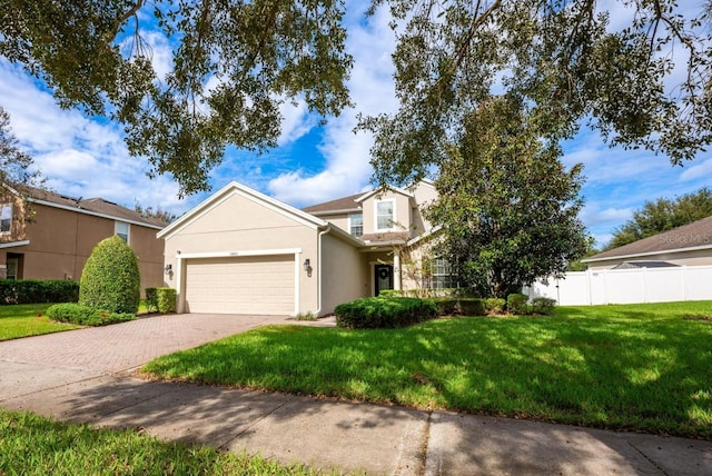 view of front of home with a front yard and a garage