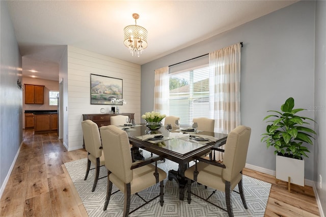 dining area featuring a chandelier and light wood-type flooring