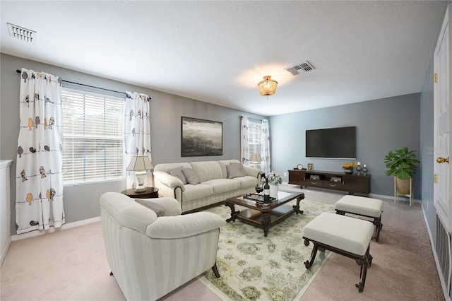 carpeted living room featuring a textured ceiling