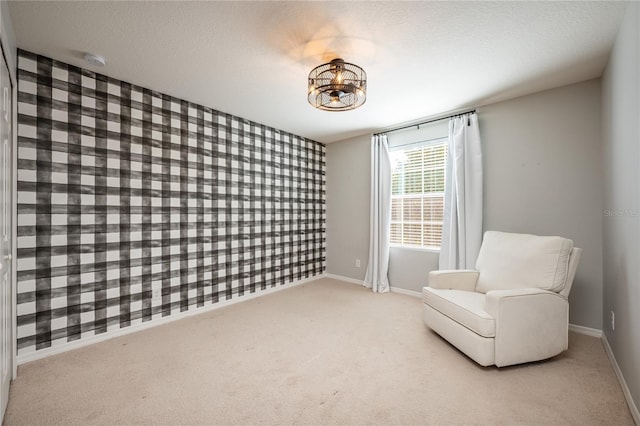 sitting room with light carpet and a textured ceiling