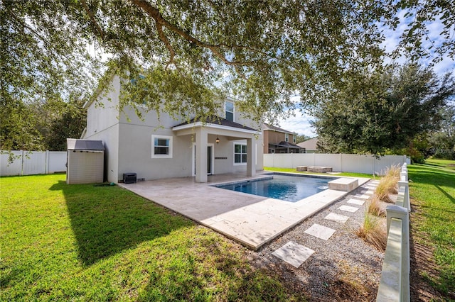 view of pool featuring a lawn and a patio